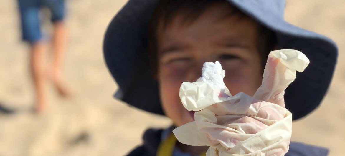 Children clean Praia da Poça, a popular small beach at the tip of the Estoril - Cascais coast, in Portugal.